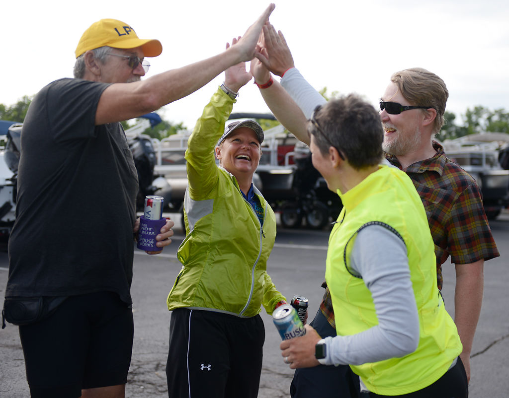 Larry Smart, Missy Brooks, Mari Matthes, and Tim Davis high five after the four completed the race